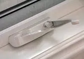 White window lock handle on frame.