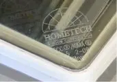 Window corner with etched brand logo.