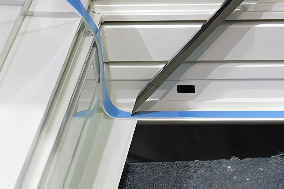 Installing tape on a metal surface edge.