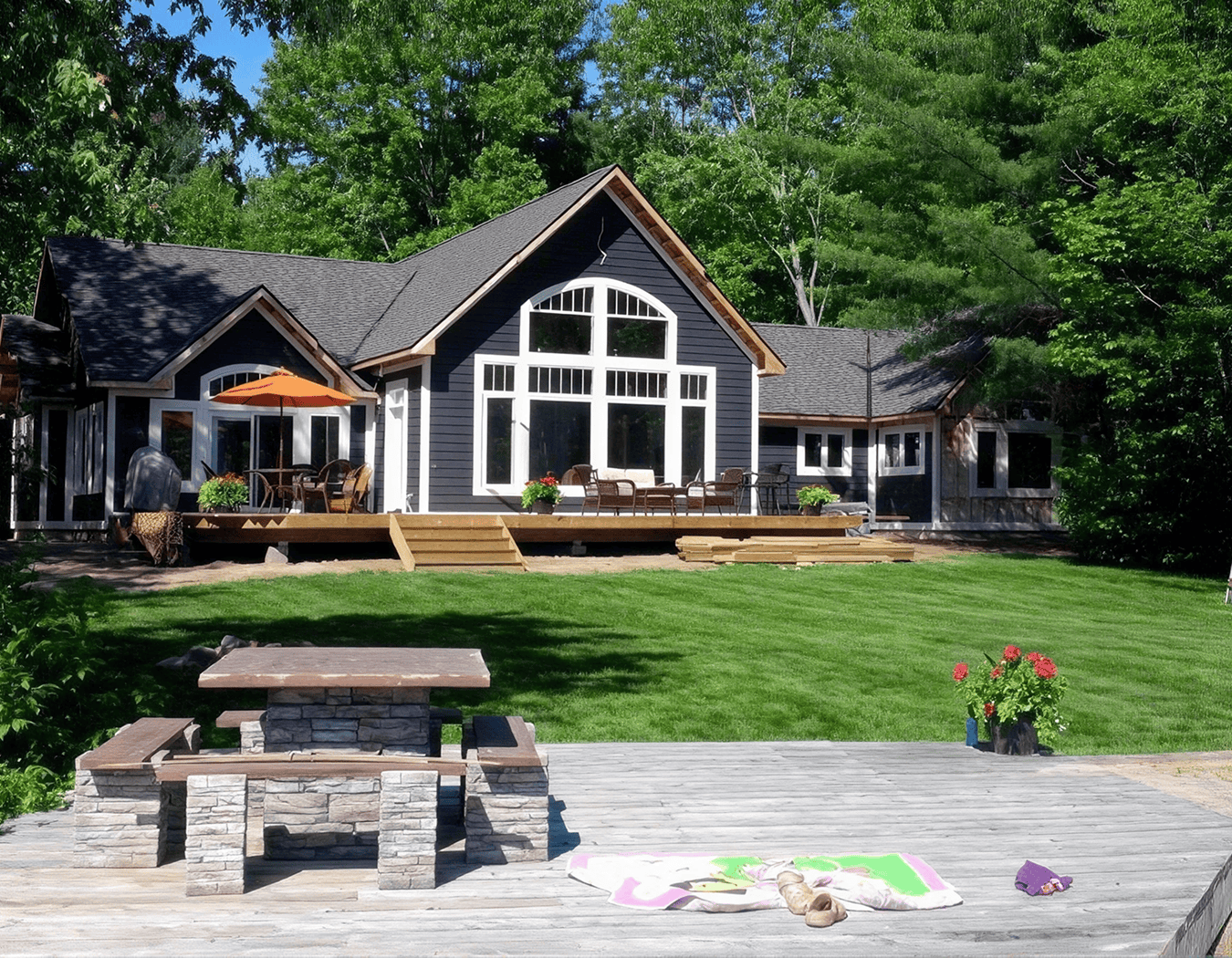 Modern house with deck and green lawn.
