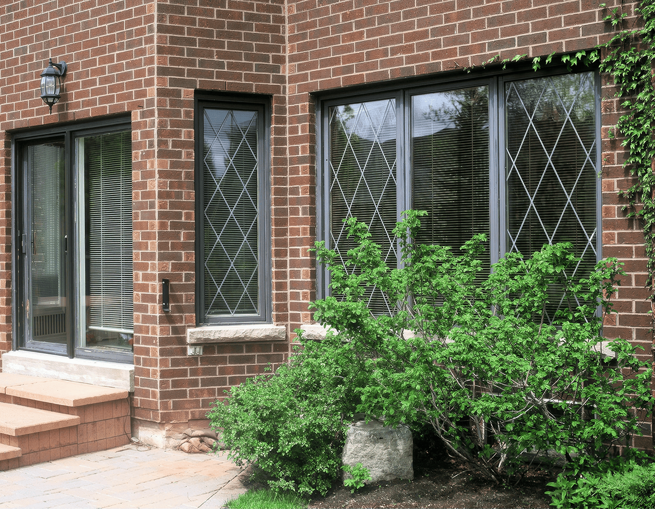 Brick house with diamond-patterned window panes.