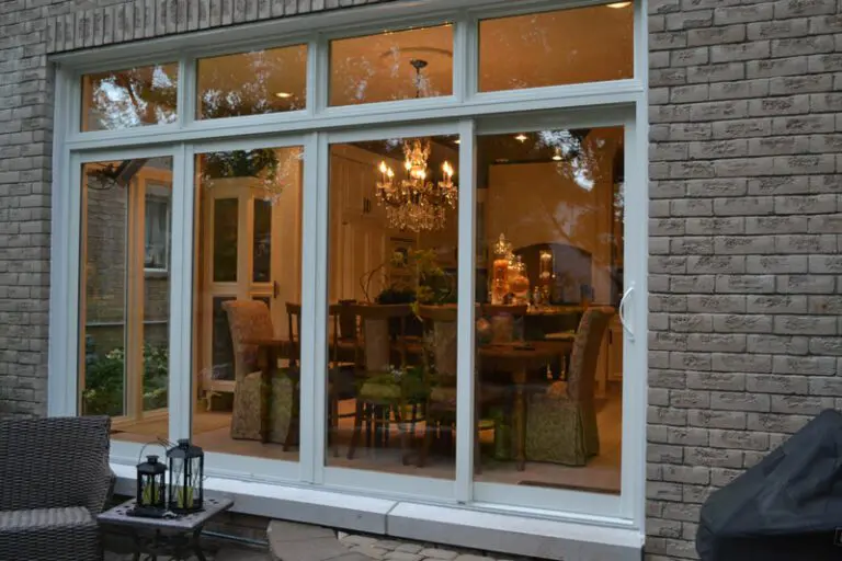 Glass doors to a warmly lit dining room.