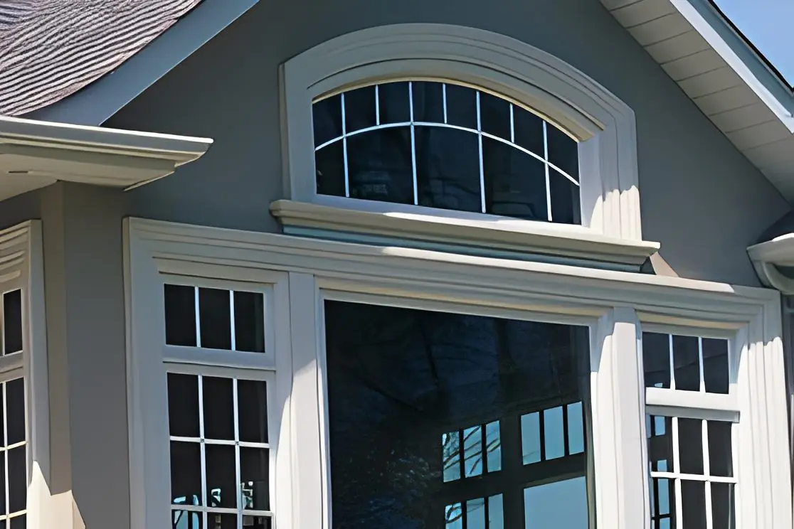 House exterior with large arched window.