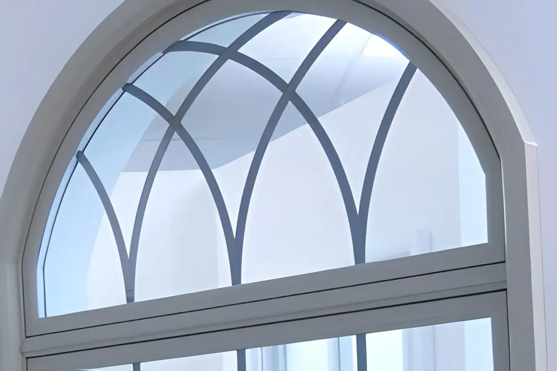 Arched window with decorative grid design.